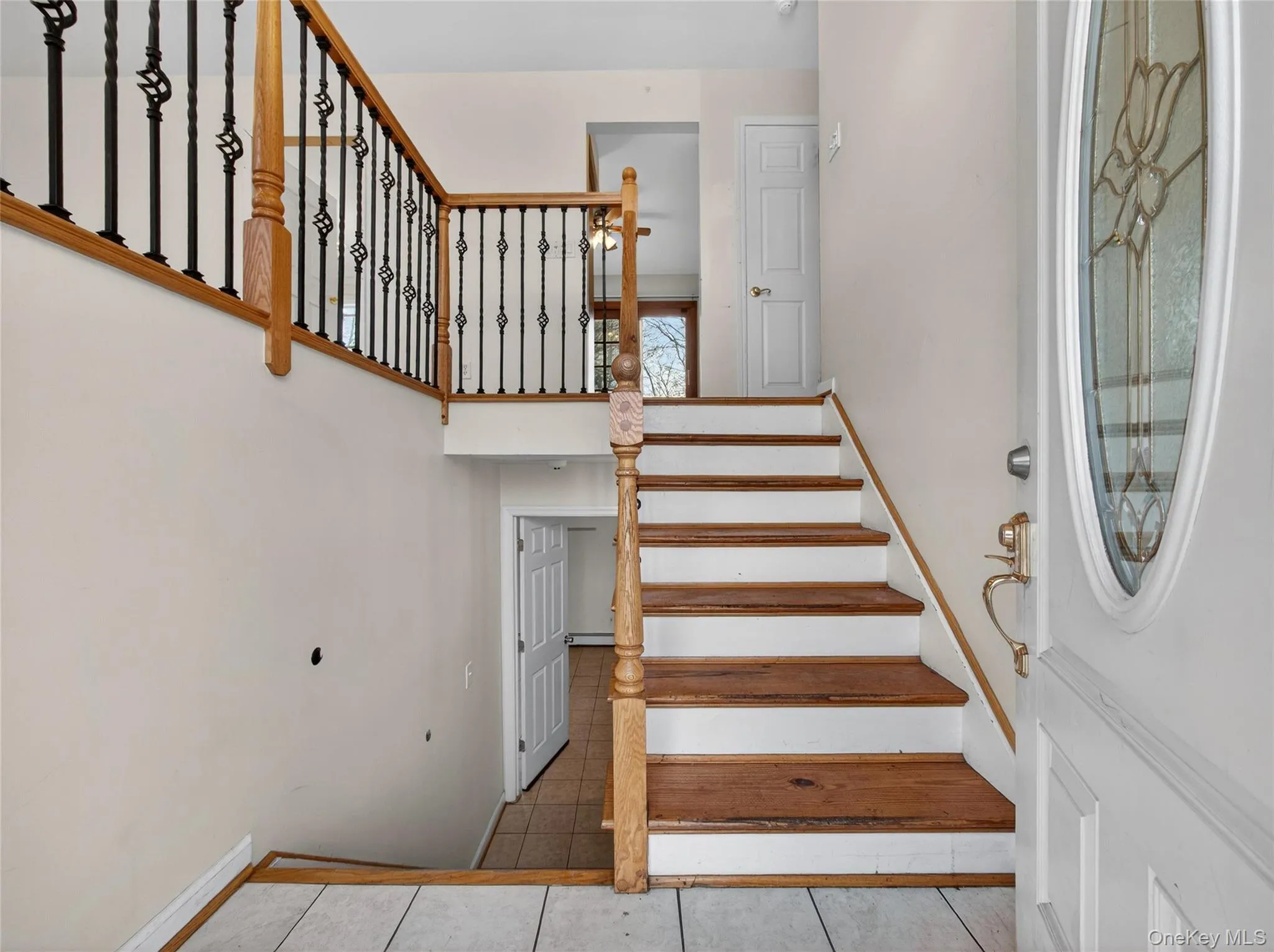 Staircase featuring tile patterned floors Staircase featuring tile patterned floors