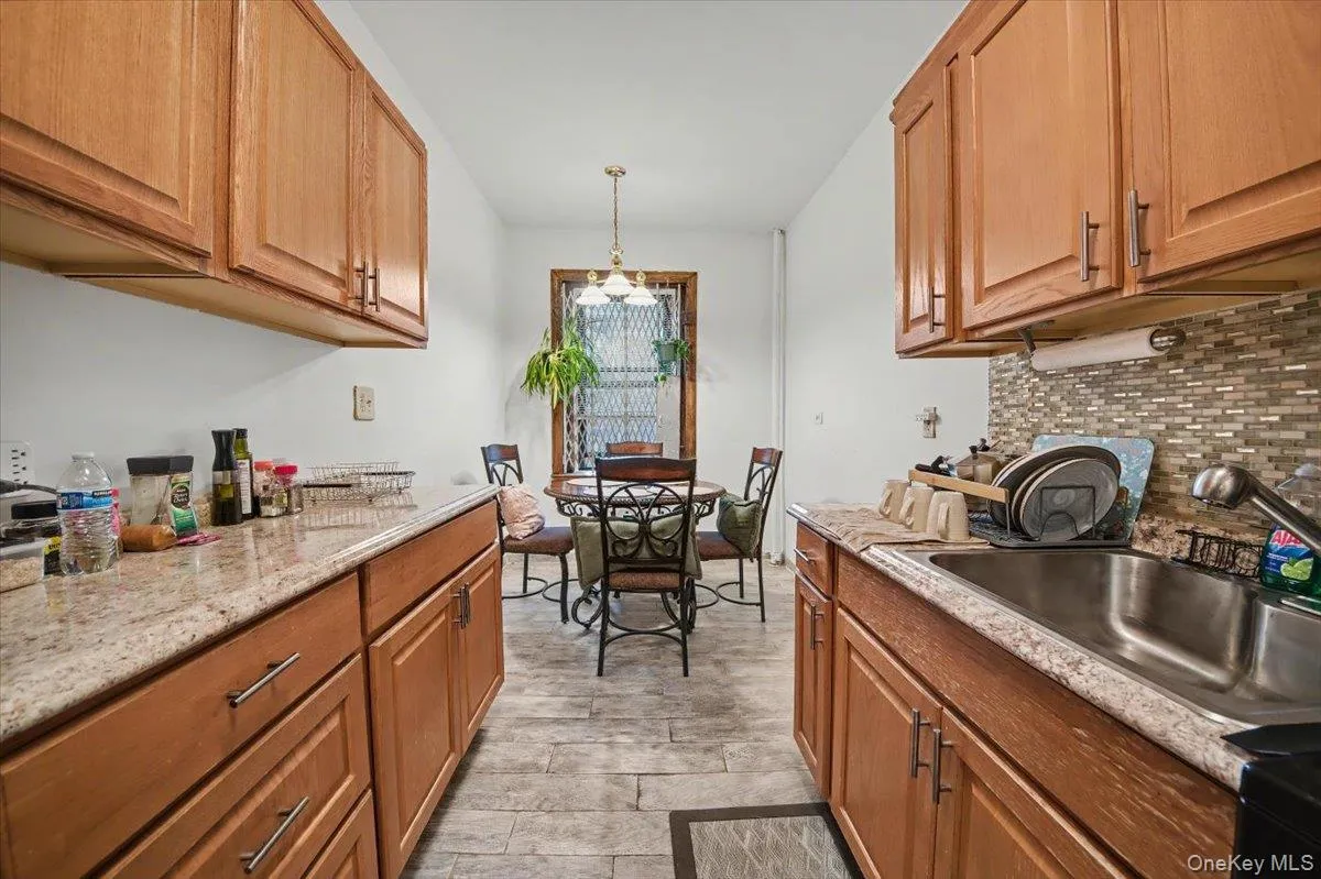 Kitchen with pendant lighting and brown cabinets Kitchen with pendant lighting and brown cabinets