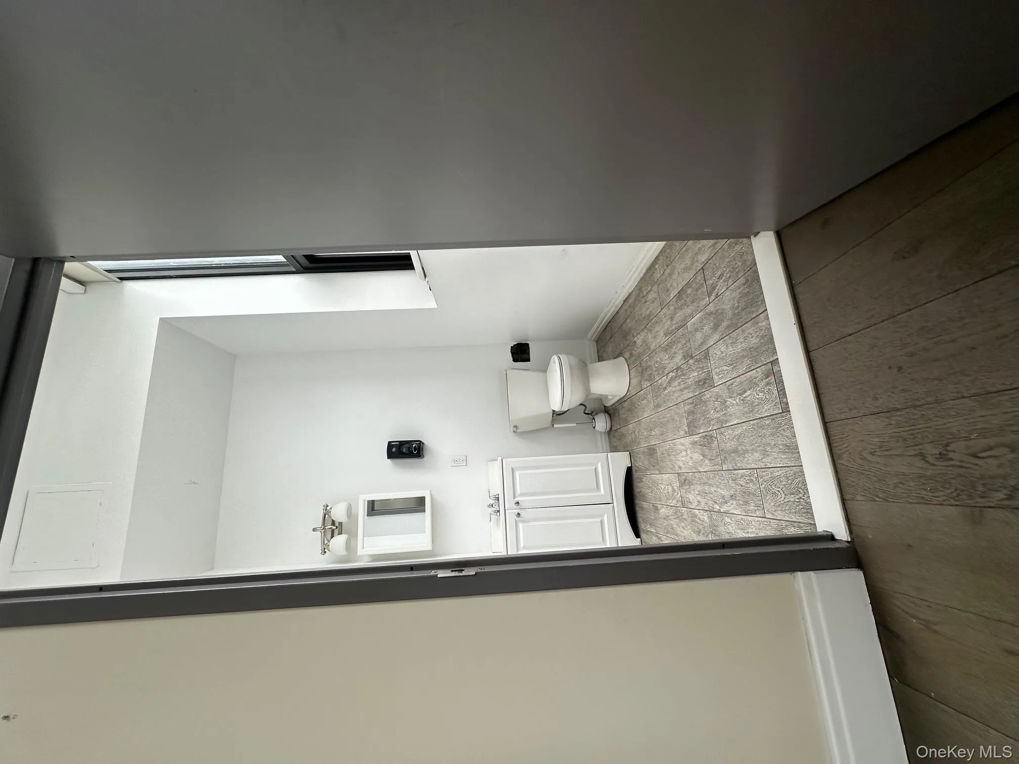 Half bathroom featuring vanity and wood-type flooring Half bathroom featuring vanity and wood-type flooring