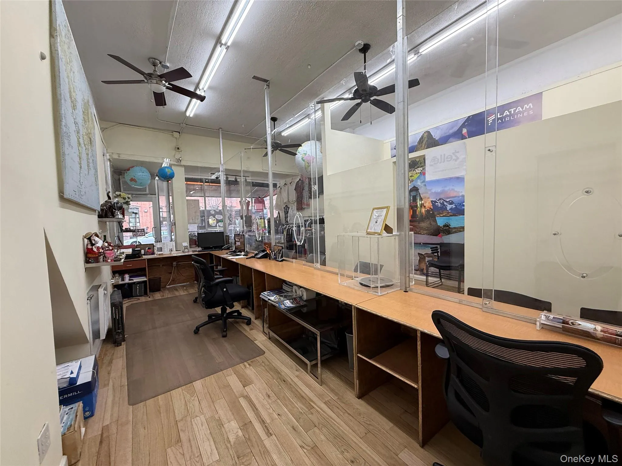 Office space with a ceiling fan, a textured ceiling, and built in study area Office space with a ceiling fan, a textured ceiling, and built in study area