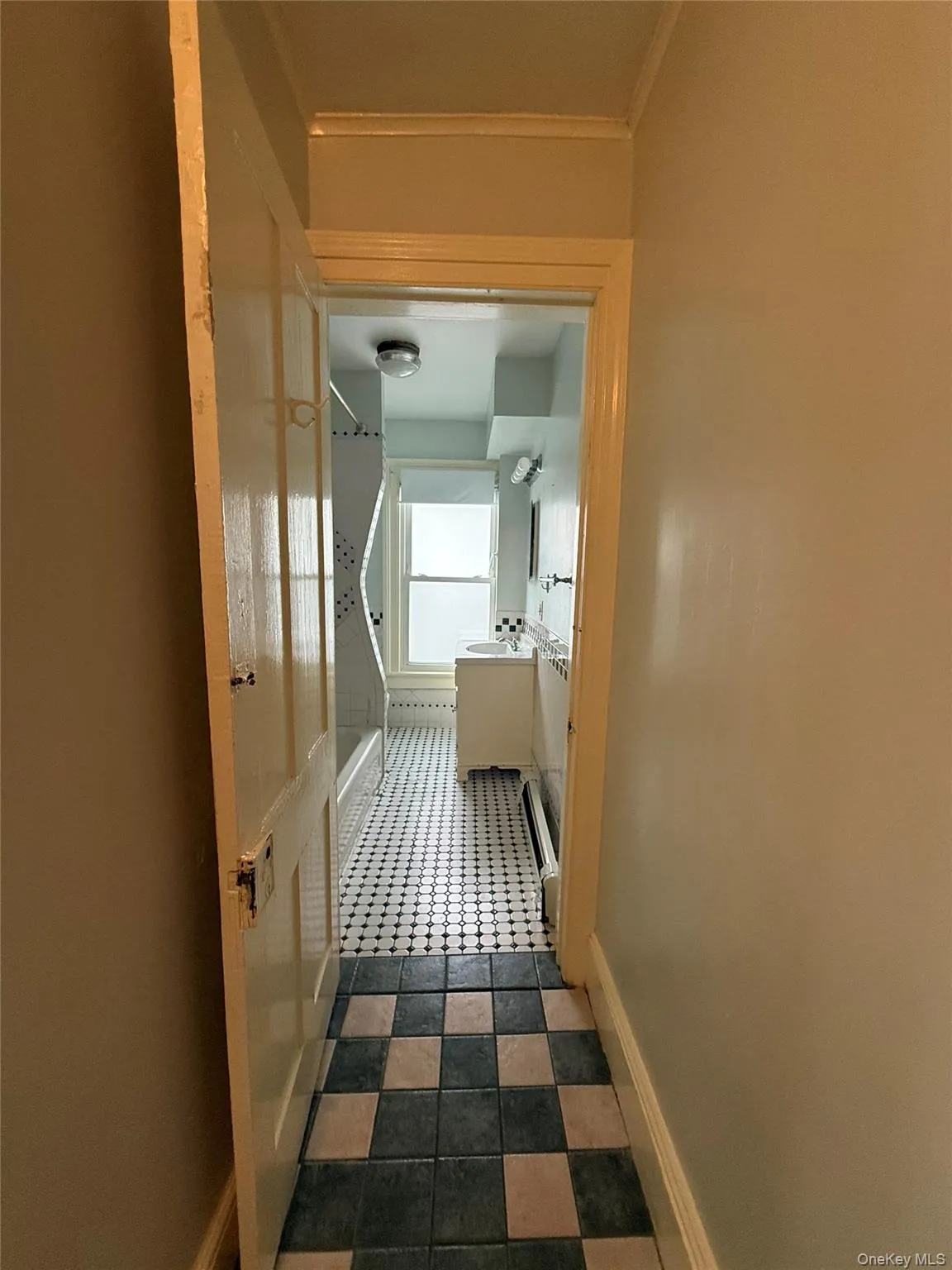 Corridor featuring dark flooring and crown molding Corridor featuring dark flooring and crown molding