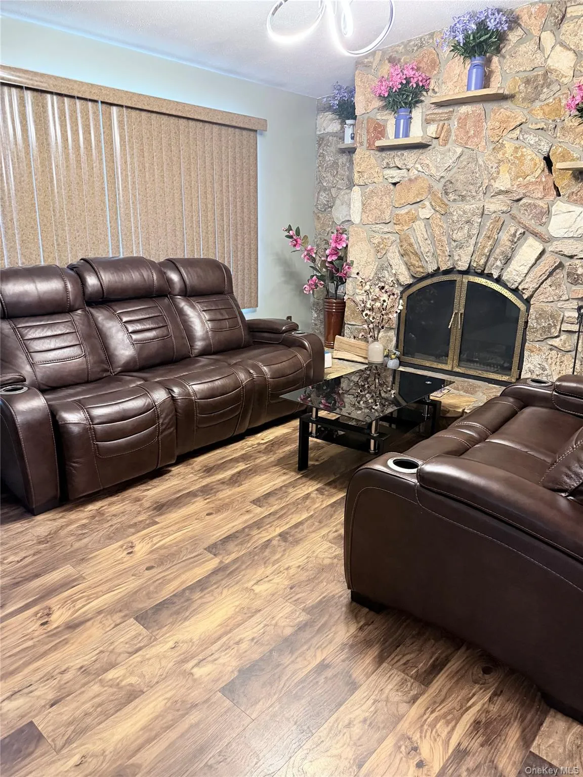 Living room with wood finished floors and a fireplace Living room with wood finished floors and a fireplace