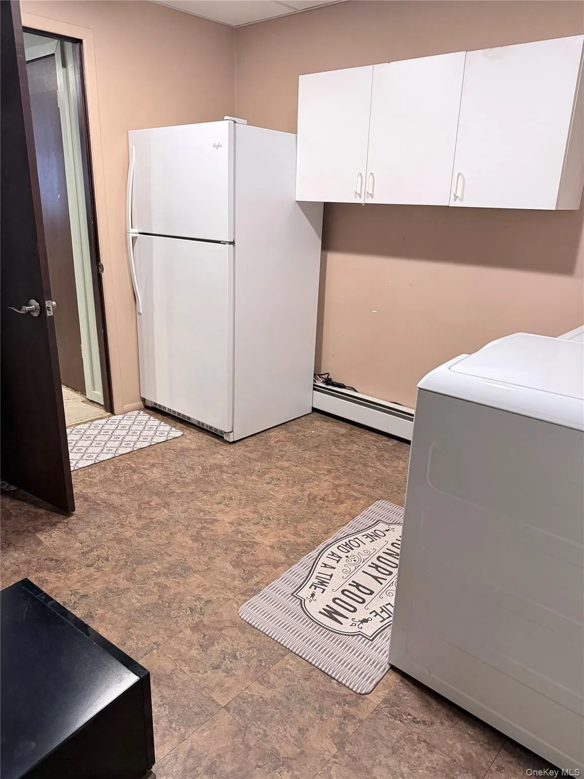 Laundry room with washer / dryer and baseboard heating Laundry room with washer / dryer and baseboard heating