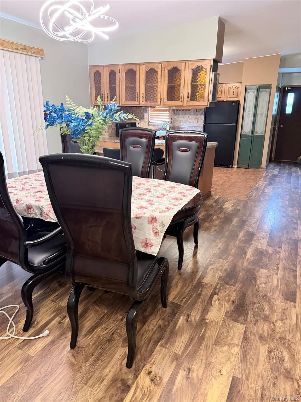 Dining area with dark wood-style floors and a chandelier Dining area with dark wood-style floors and a chandelier