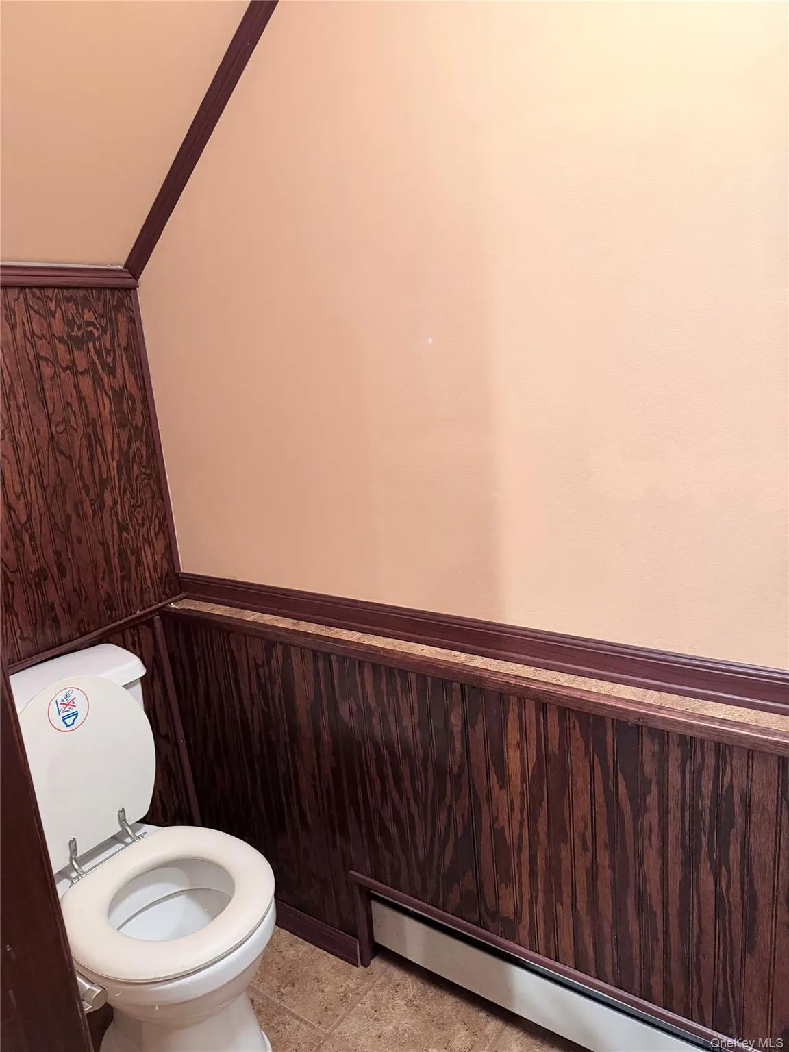 Bathroom with wainscoting, wooden walls, a baseboard heating unit, and ornamental molding Bathroom with wainscoting, wooden walls, a baseboard heating unit, and ornamental molding
