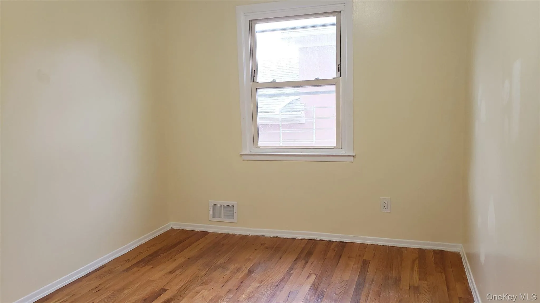 Spare room featuring baseboards and light wood finished floors Spare room featuring baseboards and light wood finished floors