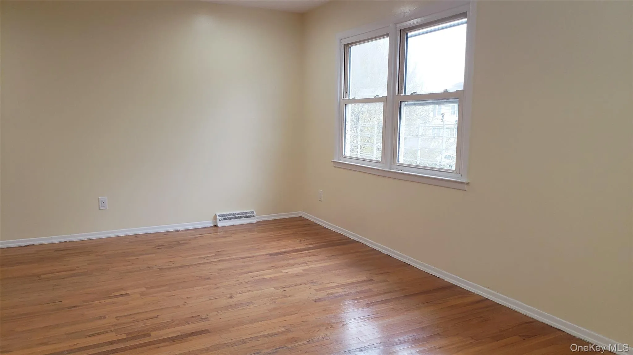 Empty room featuring light wood-style flooring and baseboards Empty room featuring light wood-style flooring and baseboards