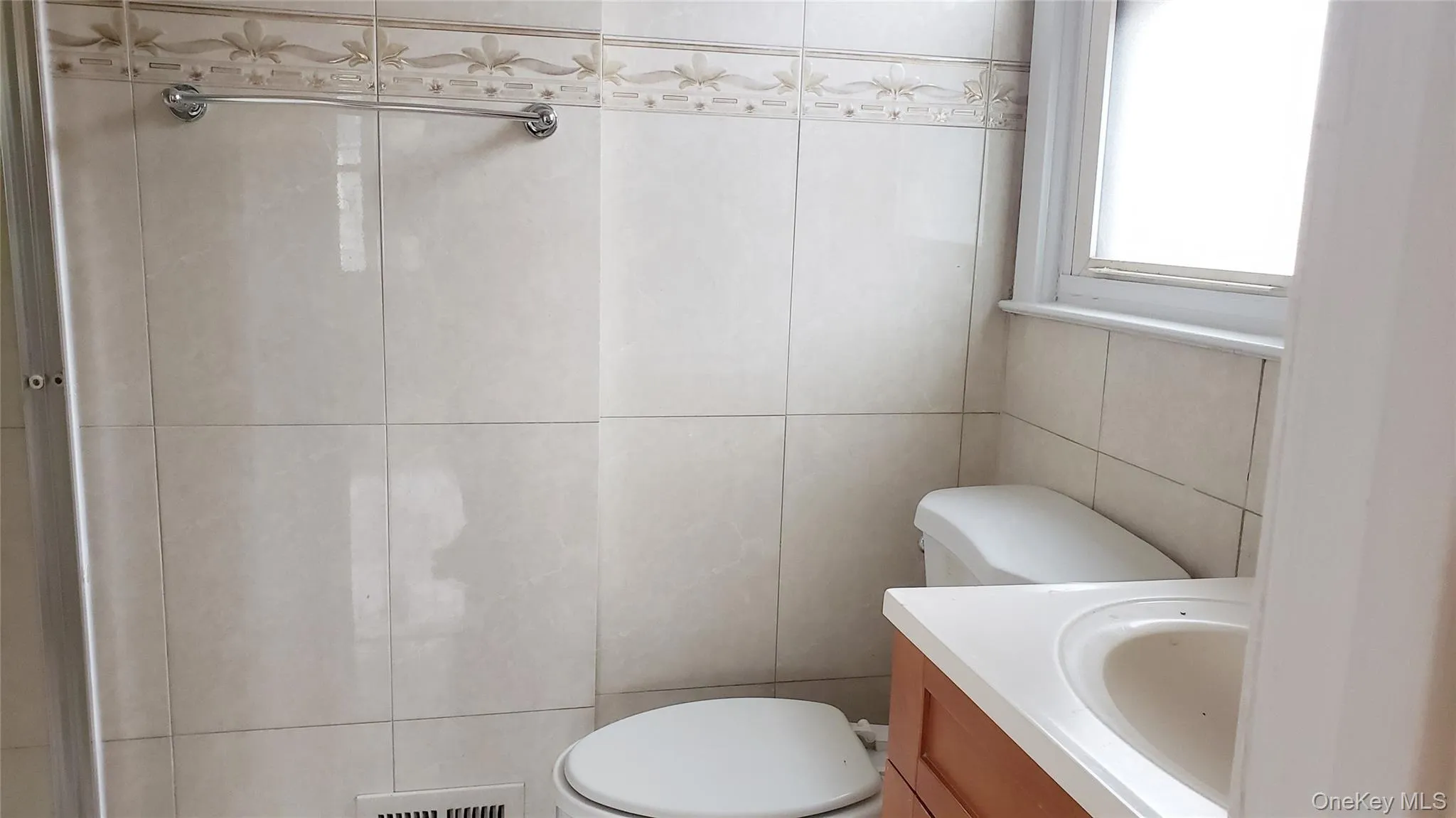 Bathroom with tile walls and vanity Bathroom with tile walls and vanity