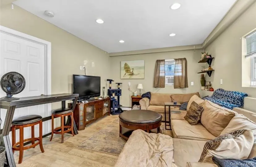 Living room with light wood-type flooring and recessed lighting Living room with light wood-type flooring and recessed lighting