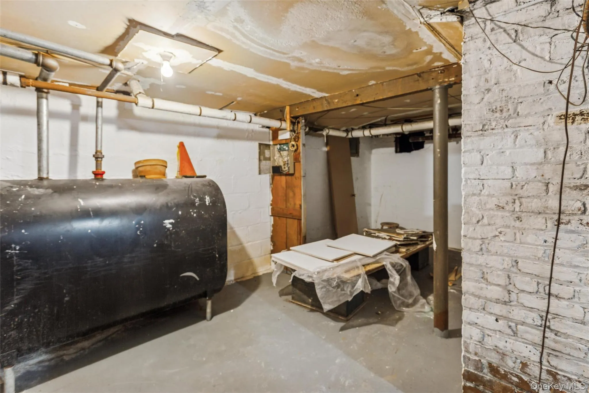 Unfinished below grade area with oil tank Unfinished below grade area with oil tank