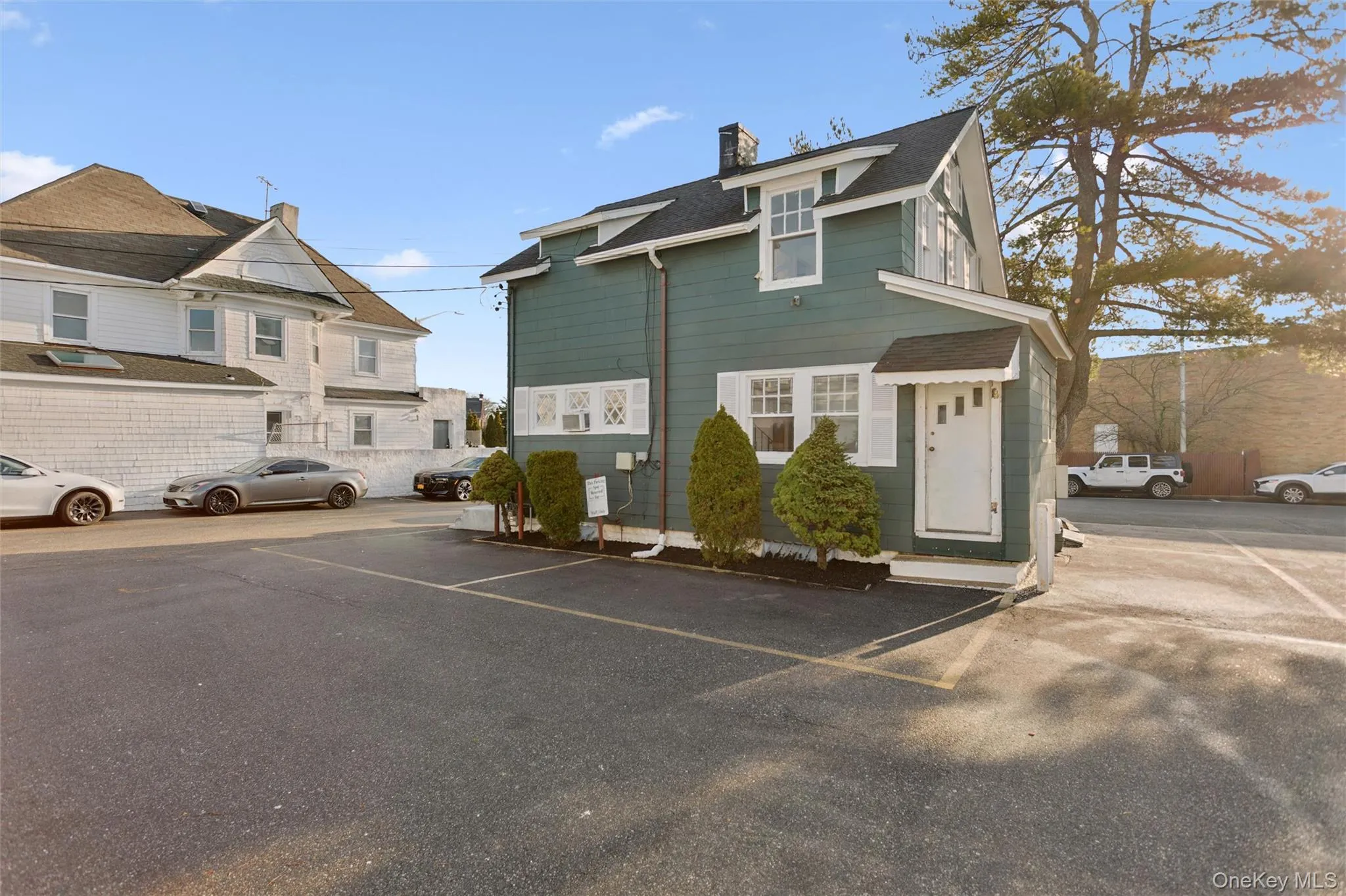 View of side of home featuring uncovered parking and a chimney View of side of home featuring uncovered parking and a chimney
