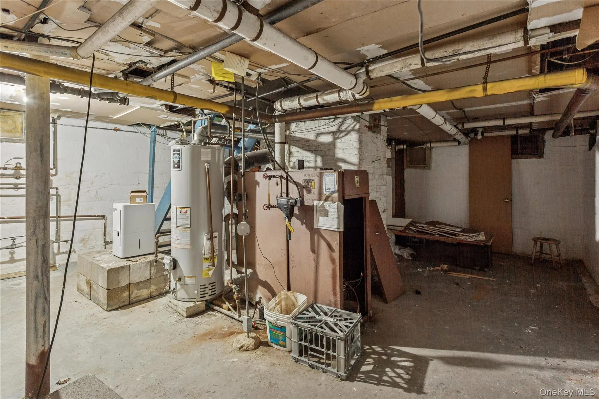 Unfinished basement featuring gas water heater Unfinished basement featuring gas water heater