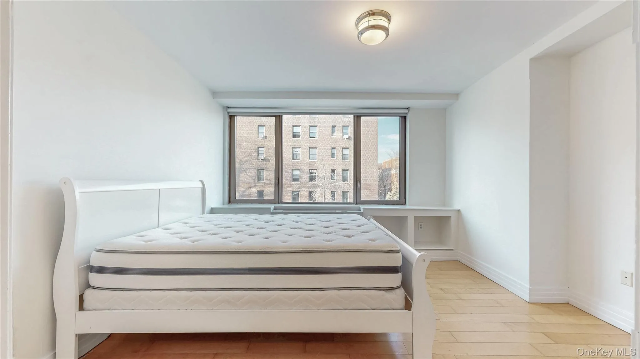 Bedroom with wood finished floors and baseboards Bedroom with wood finished floors and baseboards