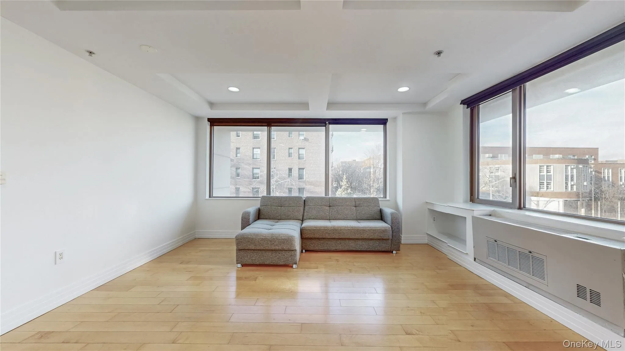 Sitting room featuring light wood-style flooring, coffered ceiling, recessed lighting, and beam ceiling Sitting room featuring light wood-style flooring, coffered ceiling, recessed lighting, and beam ceiling
