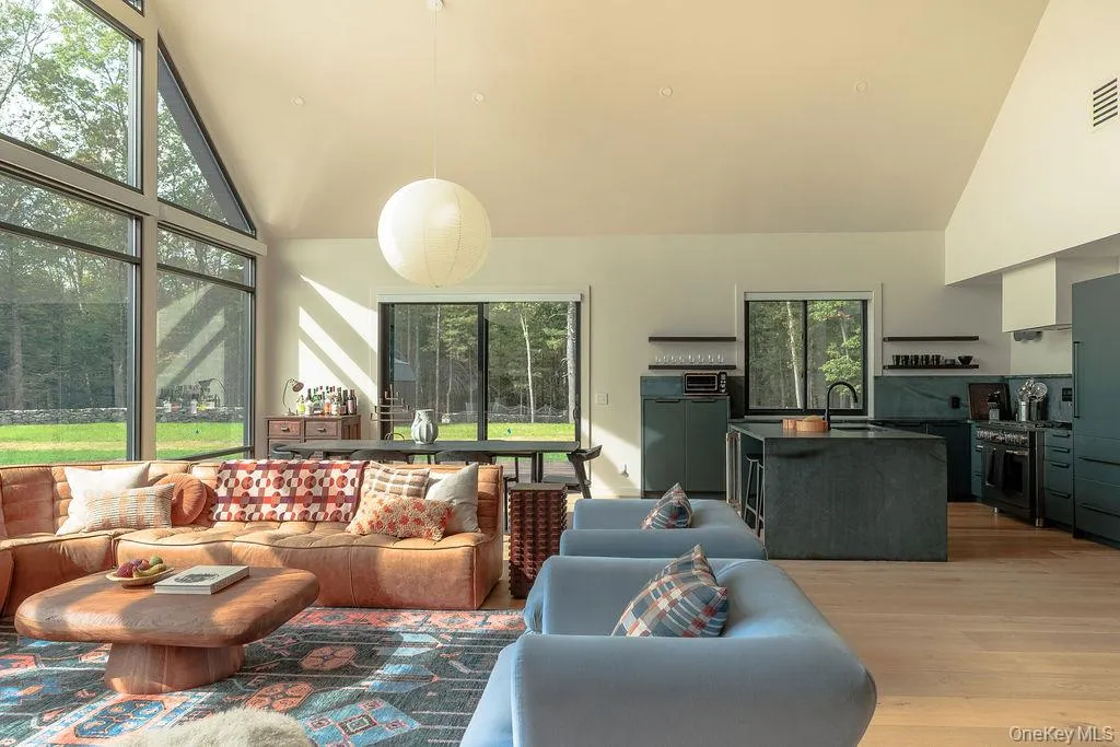 Living room with high vaulted ceiling and light wood finished floors Living room with high vaulted ceiling and light wood finished floors