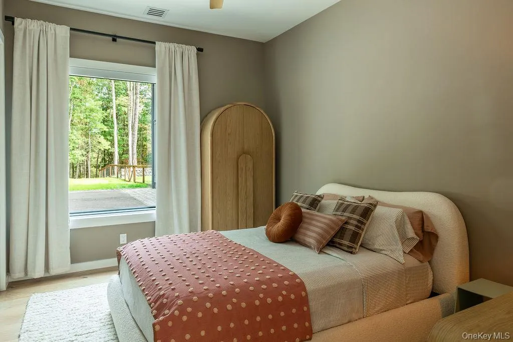 Bedroom with wood finished floors and ceiling fan Bedroom with wood finished floors and ceiling fan