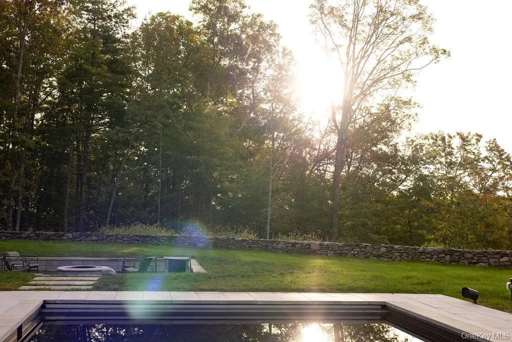 View of green lawn with a patio area View of green lawn with a patio area