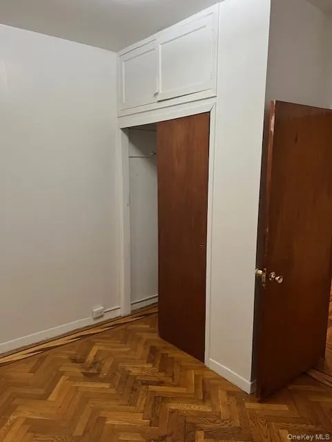 Unfurnished bedroom with a closet and baseboards Unfurnished bedroom with a closet and baseboards