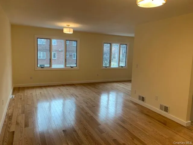 Unfurnished room featuring light wood finished floors and baseboards Unfurnished room featuring light wood finished floors and baseboards