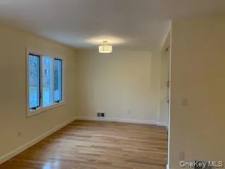Empty room with light wood-style flooring and baseboards Empty room with light wood-style flooring and baseboards