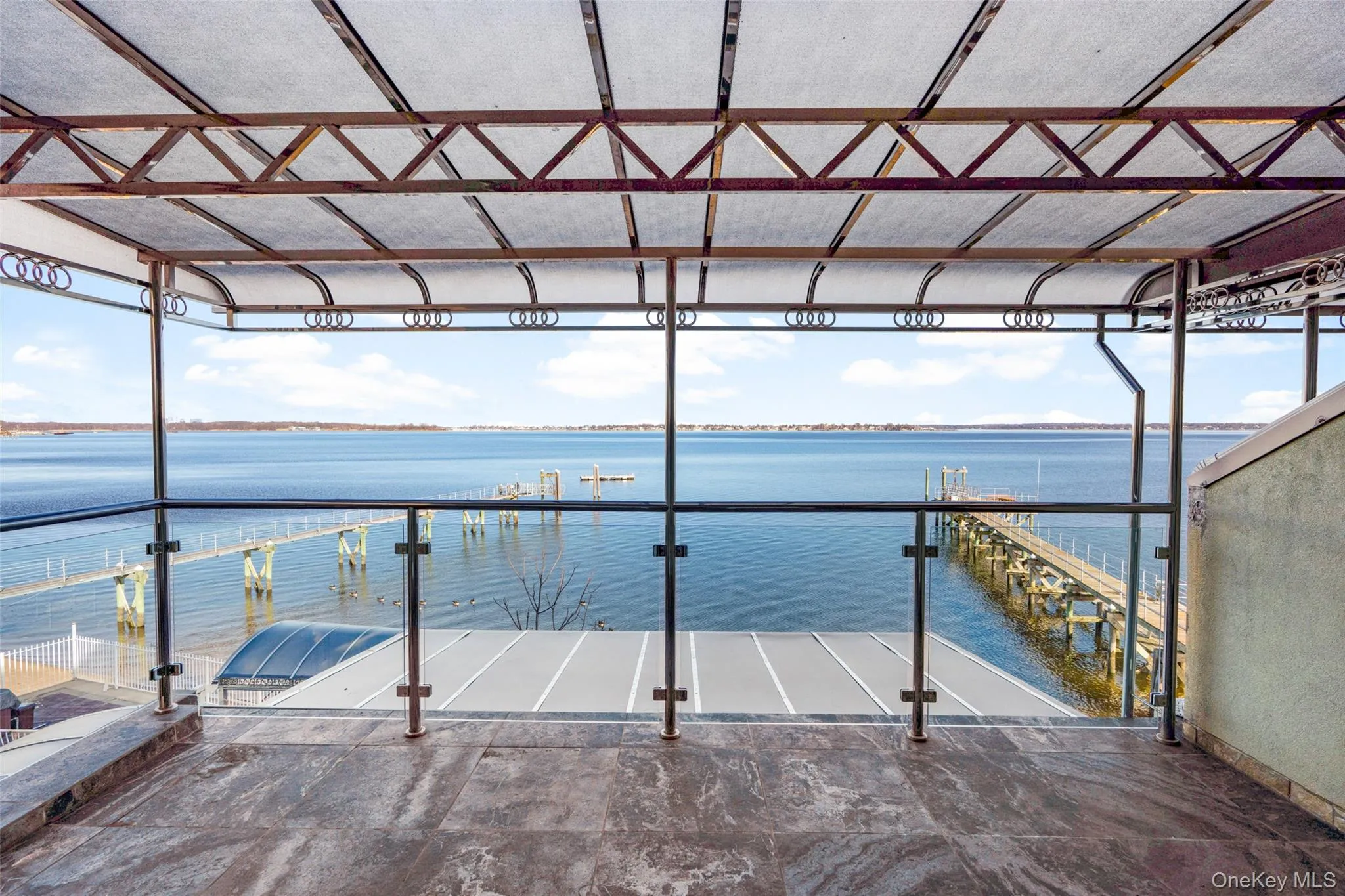 Dock featuring a balcony and a water view Dock featuring a balcony and a water view
