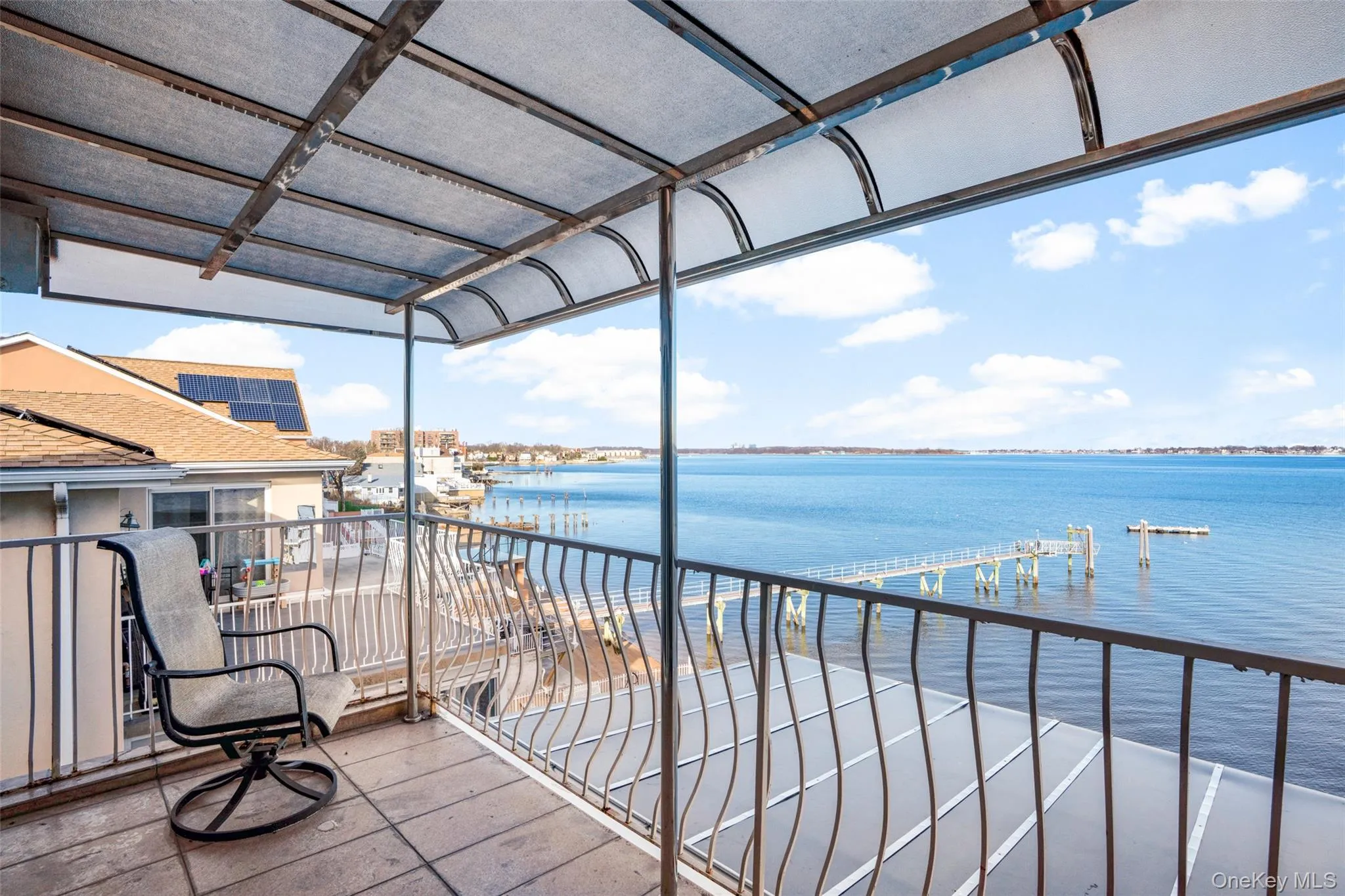 Balcony with a sunroom and a water view Balcony with a sunroom and a water view