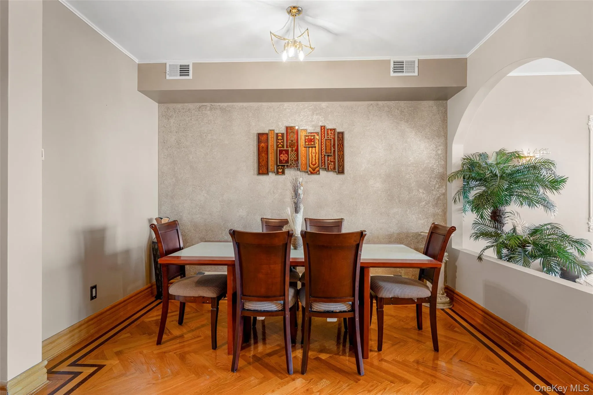 Dining space featuring ornamental molding and a chandelier Dining space featuring ornamental molding and a chandelier