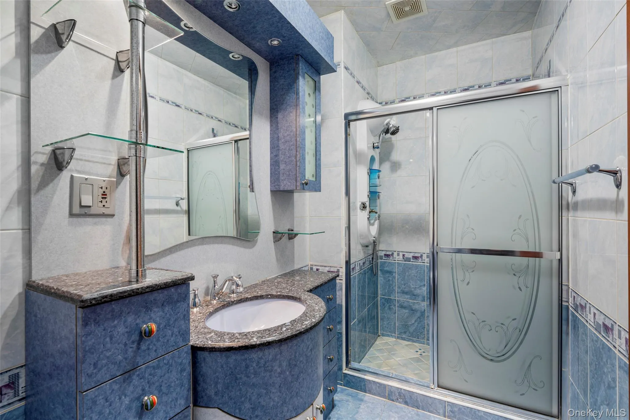 Bathroom featuring vanity and a stall shower Bathroom featuring vanity and a stall shower