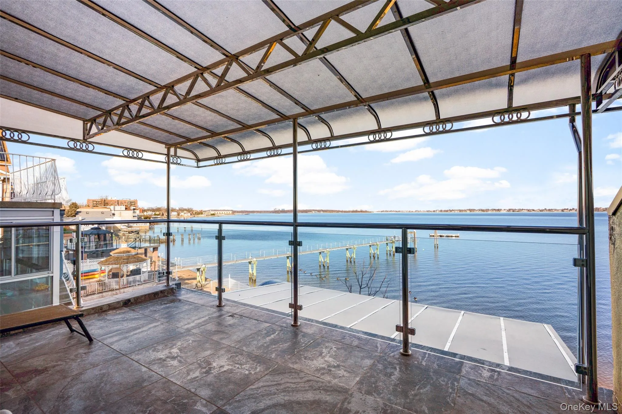 Dock featuring a water view and a balcony Dock featuring a water view and a balcony