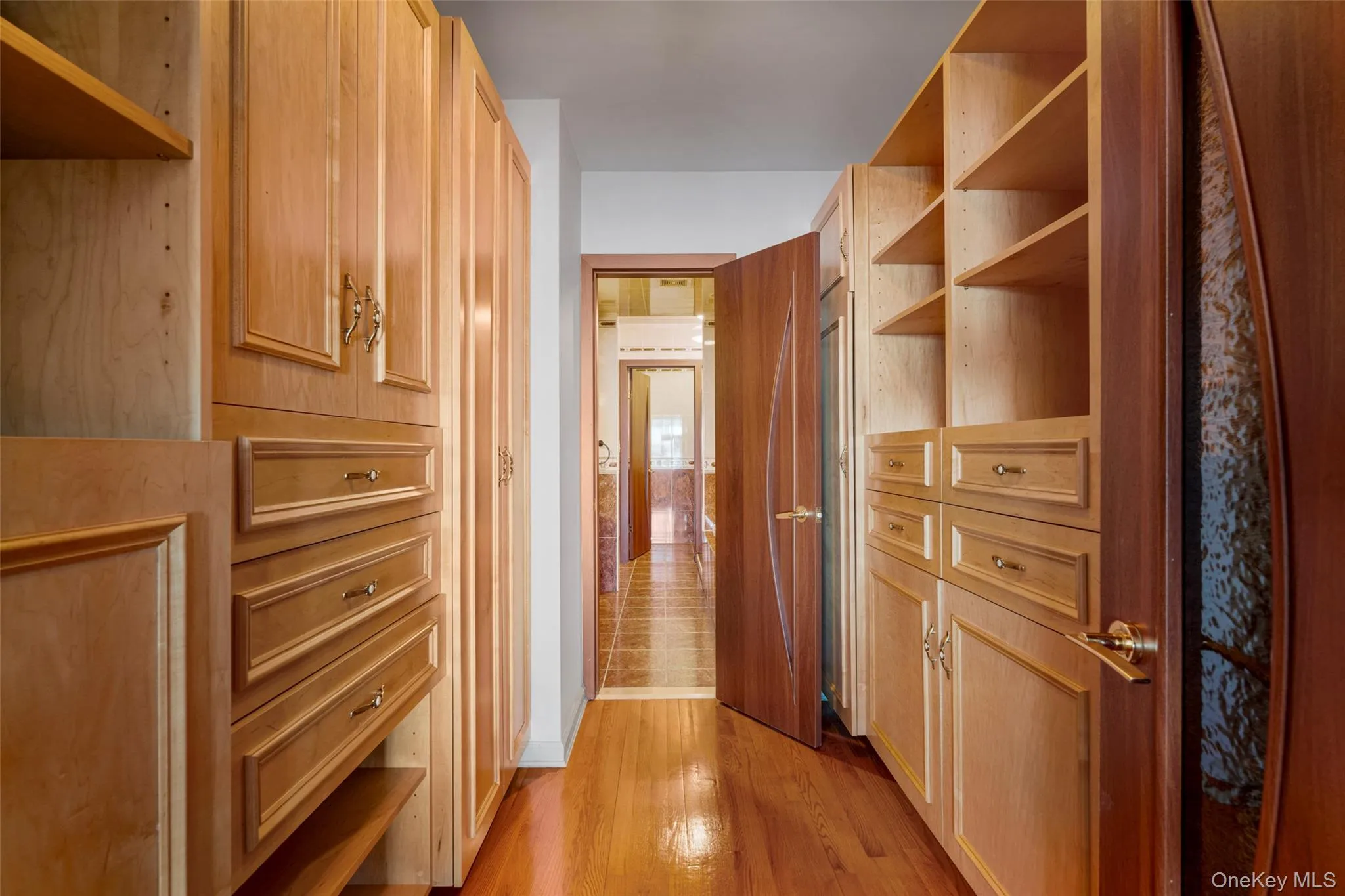 Hallway with light wood finished floors and baseboards Hallway with light wood finished floors and baseboards