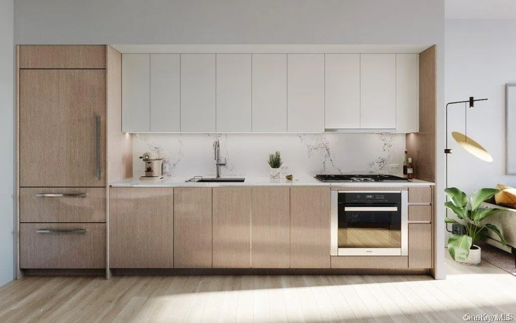 Kitchen with modern cabinets, wall oven, tasteful backsplash, white cabinetry, and light brown cabinets Kitchen with modern cabinets, wall oven, tasteful backsplash, white cabinetry, and light brown cabinets
