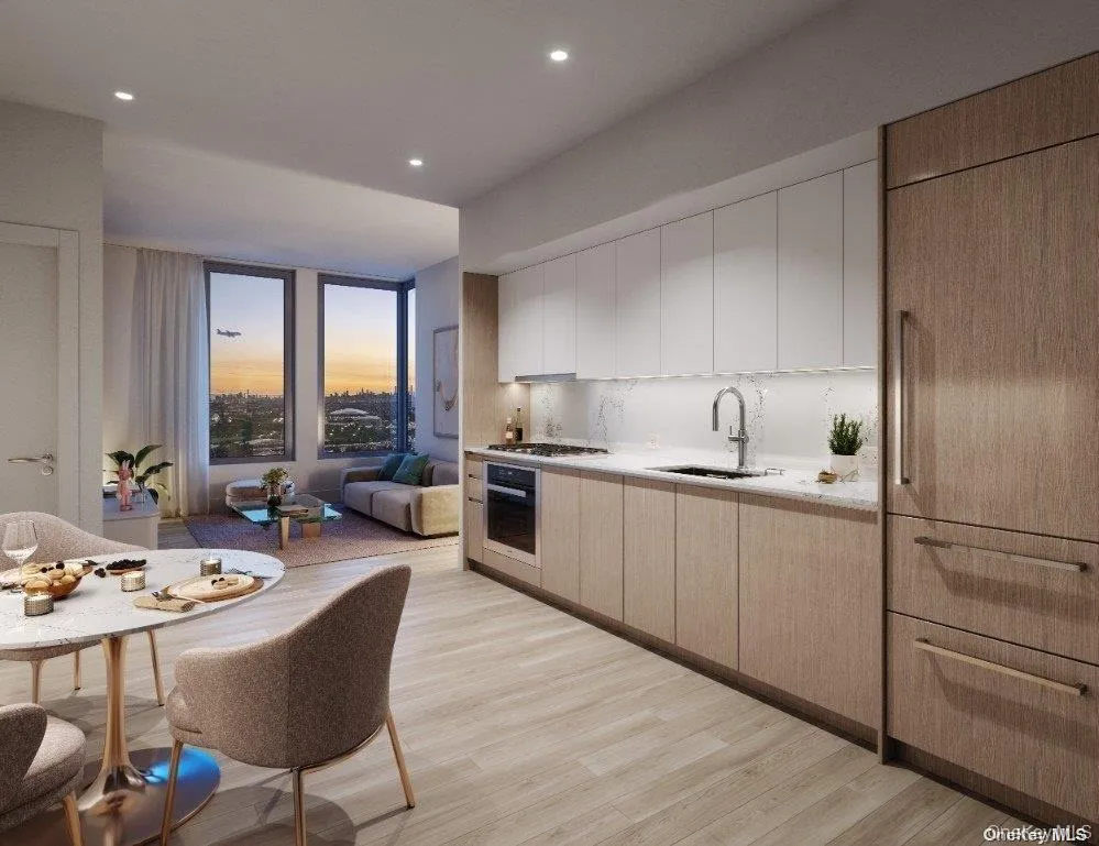 Kitchen with modern cabinets, light wood finished floors, white cabinetry, oven, and recessed lighting Kitchen with modern cabinets, light wood finished floors, white cabinetry, oven, and recessed lighting