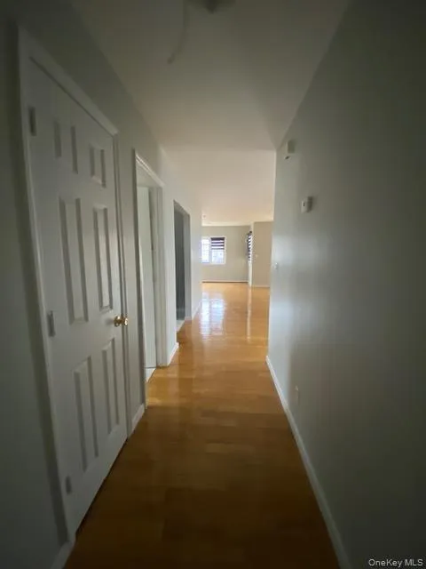 Corridor with baseboards and wood finished floors Corridor with baseboards and wood finished floors