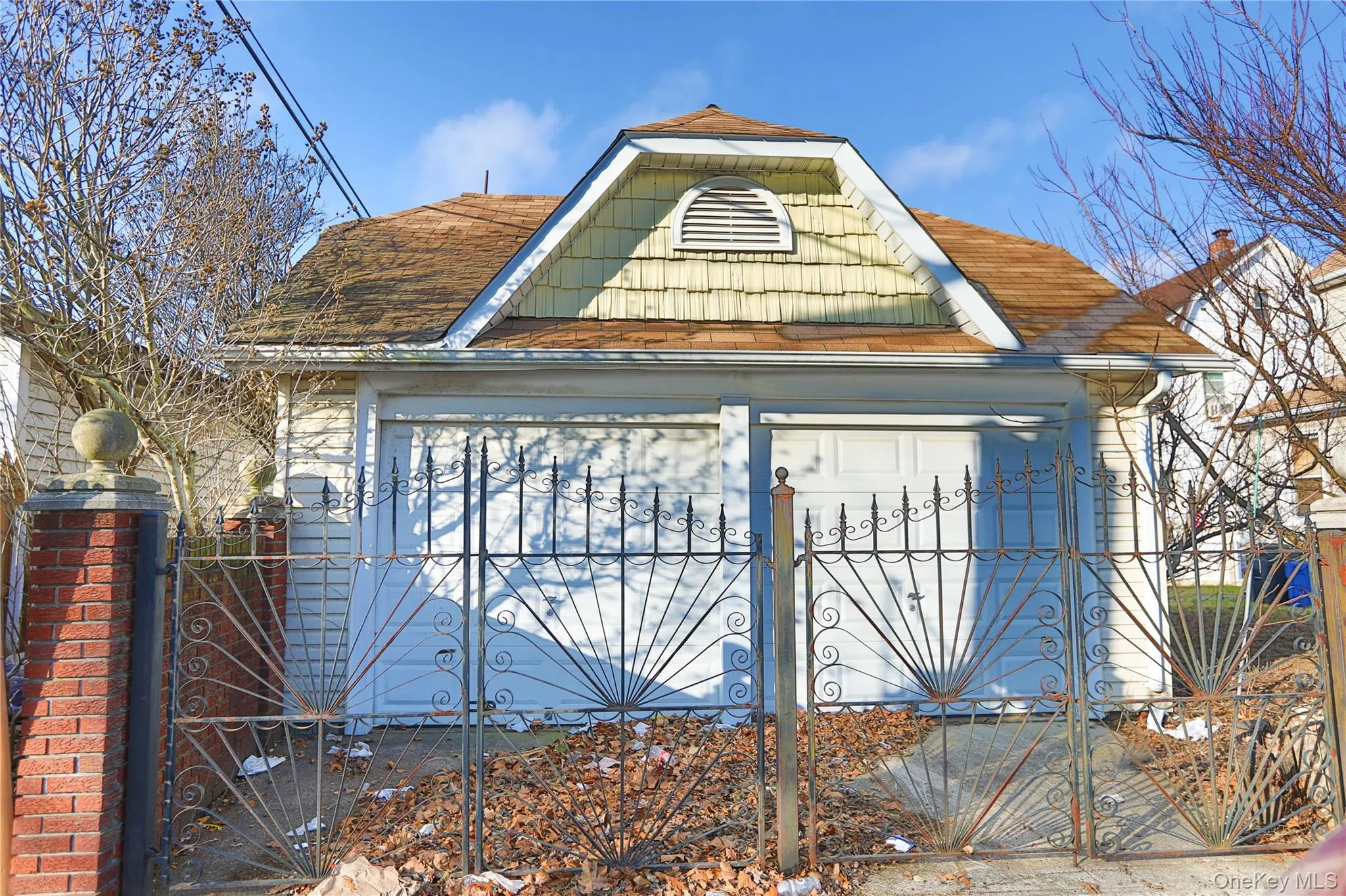 View of home's exterior featuring a gate, a garage, and roof with shingles View of home's exterior featuring a gate, a garage, and roof with shingles