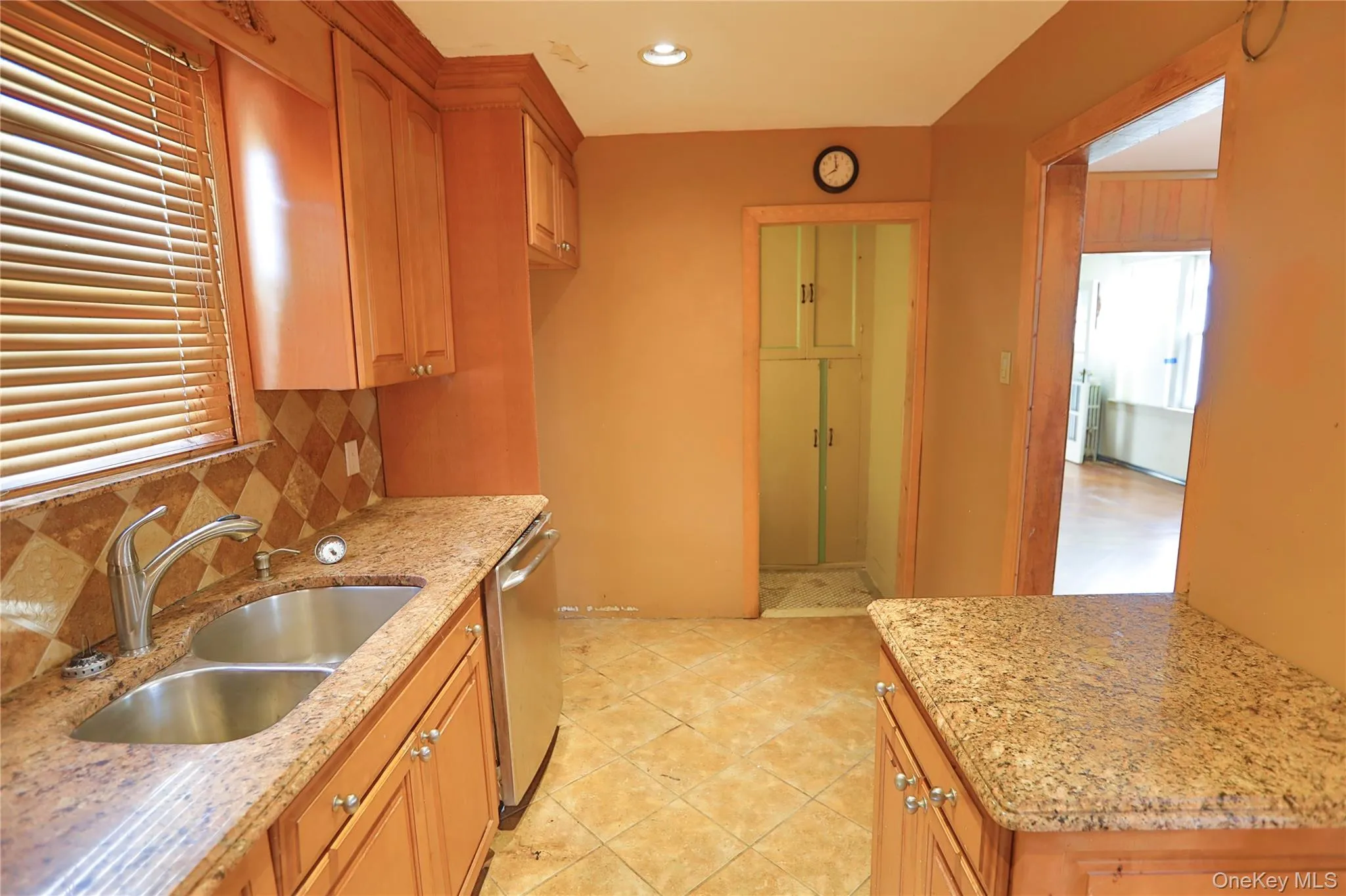 Kitchen featuring light stone counters, plenty of natural light, dishwasher, decorative backsplash, and recessed lighting Kitchen featuring light stone counters, plenty of natural light, dishwasher, decorative backsplash, and recessed lighting