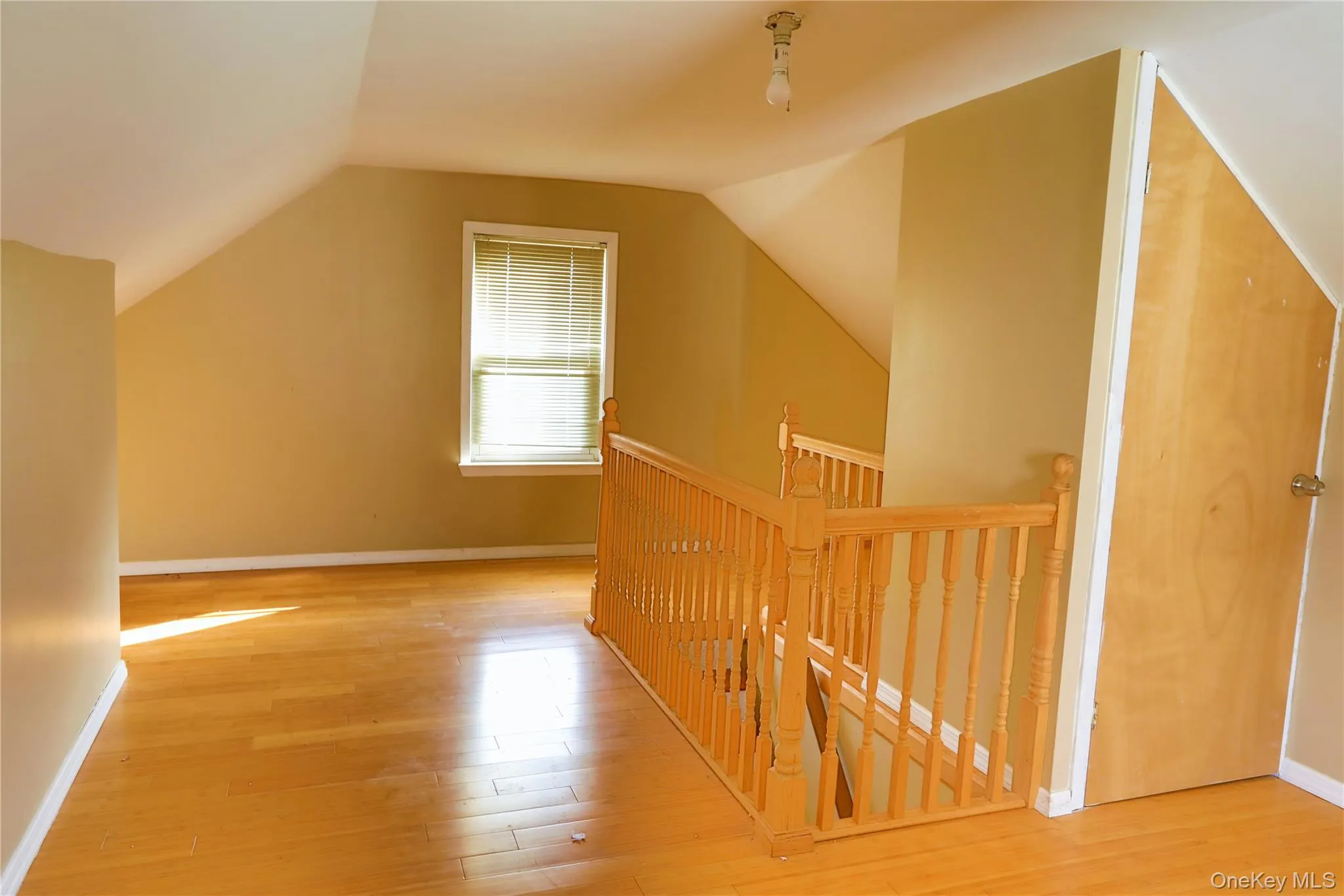 Bonus room with light wood-type flooring and vaulted ceiling Bonus room with light wood-type flooring and vaulted ceiling