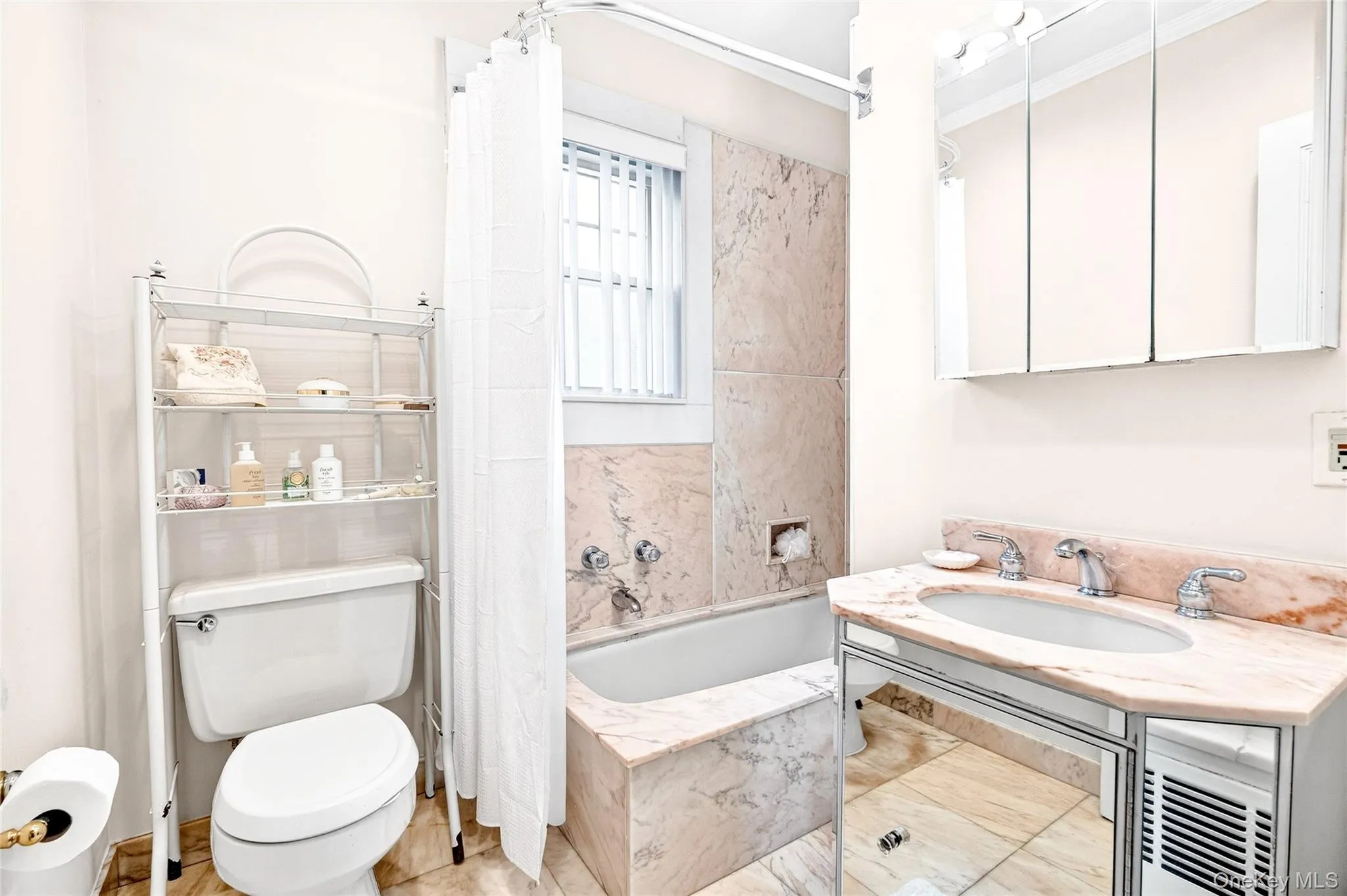 Full bathroom with a sink and a combined bath / shower with marble appearance Full bathroom with a sink and a combined bath / shower with marble appearance