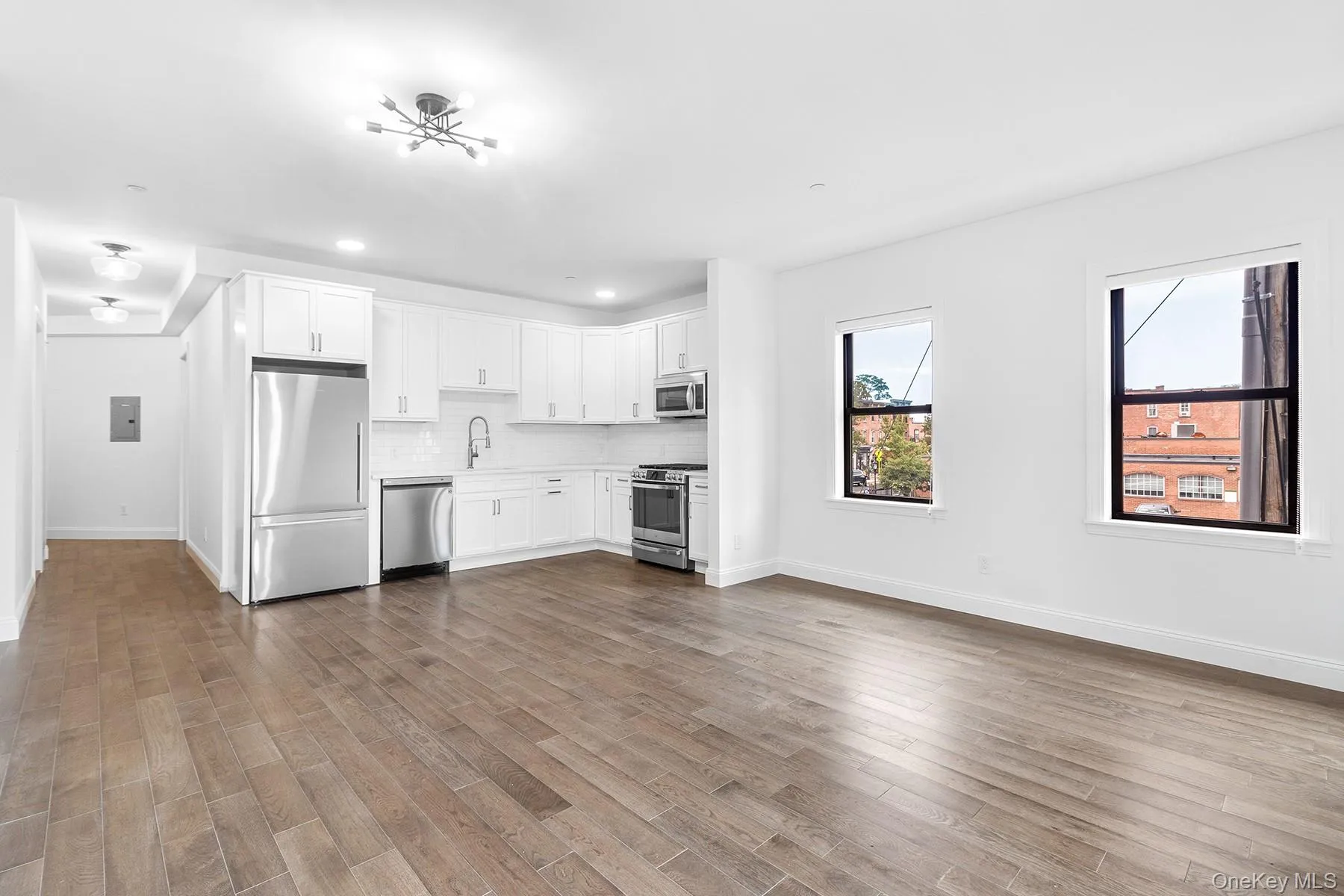 Photo is taken from oversized living room, facing kitchen + hallway Photo is taken from oversized living room, facing kitchen + hallway