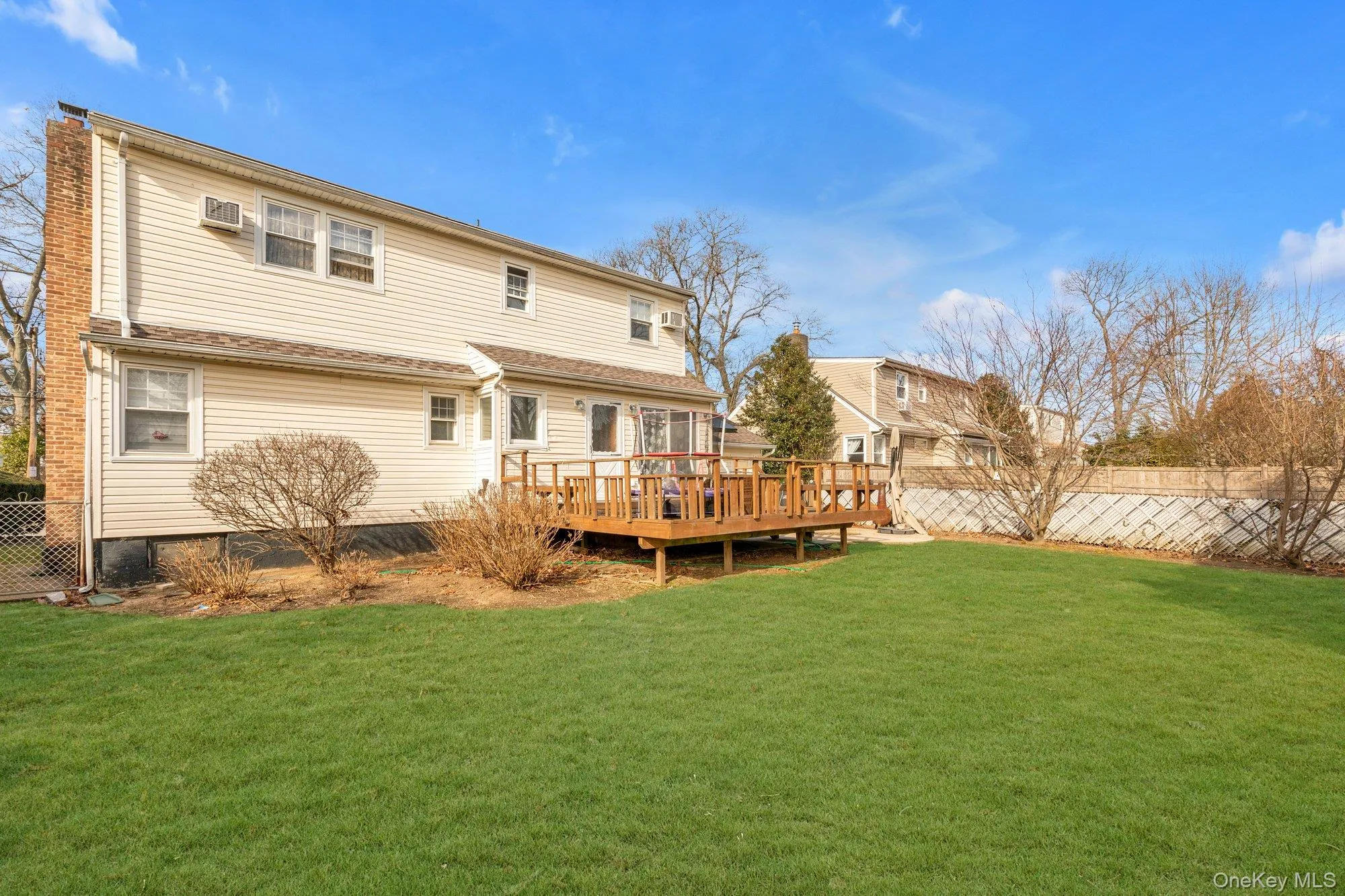 Rear view of house featuring a wooden deck Rear view of house featuring a wooden deck