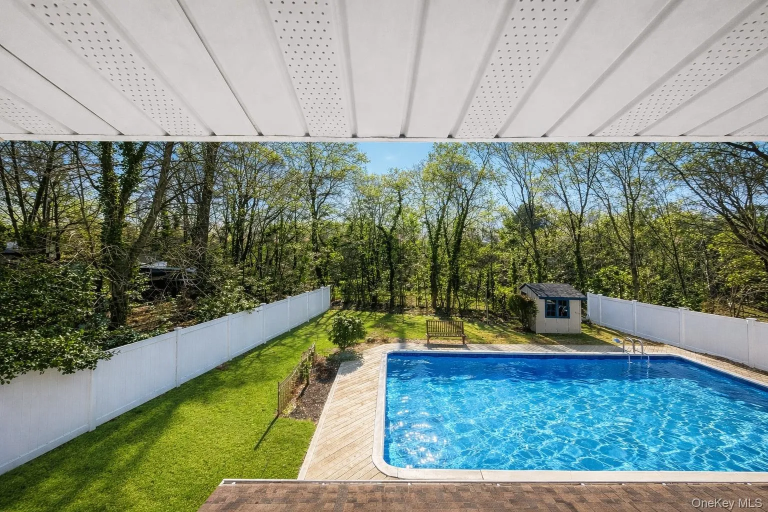 View of swimming pool featuring a fenced backyard and a storage unit View of swimming pool featuring a fenced backyard and a storage unit
