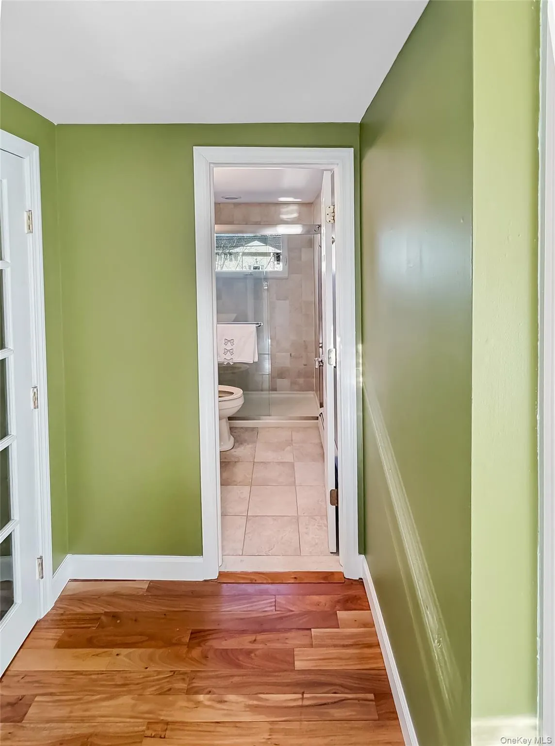 Hallway featuring wood finished floors and baseboards Hallway featuring wood finished floors and baseboards