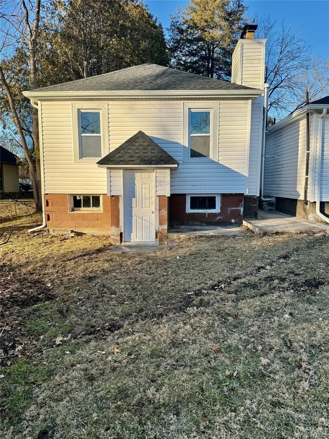 View of front of property with a chimney and a shingled roof View of front of property with a chimney and a shingled roof