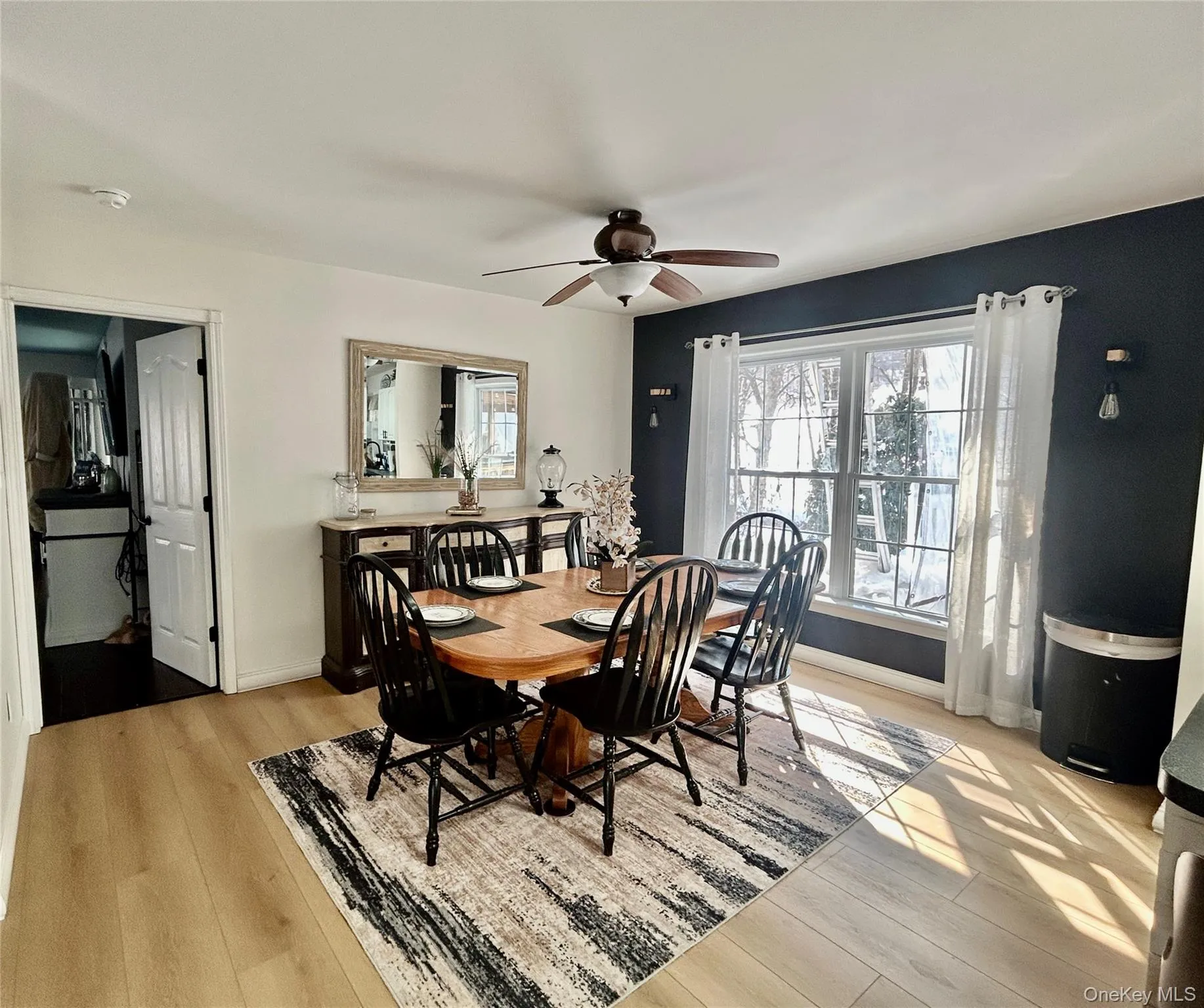 Dining space featuring a ceiling fan and light wood-style flooring Dining space featuring a ceiling fan and light wood-style flooring