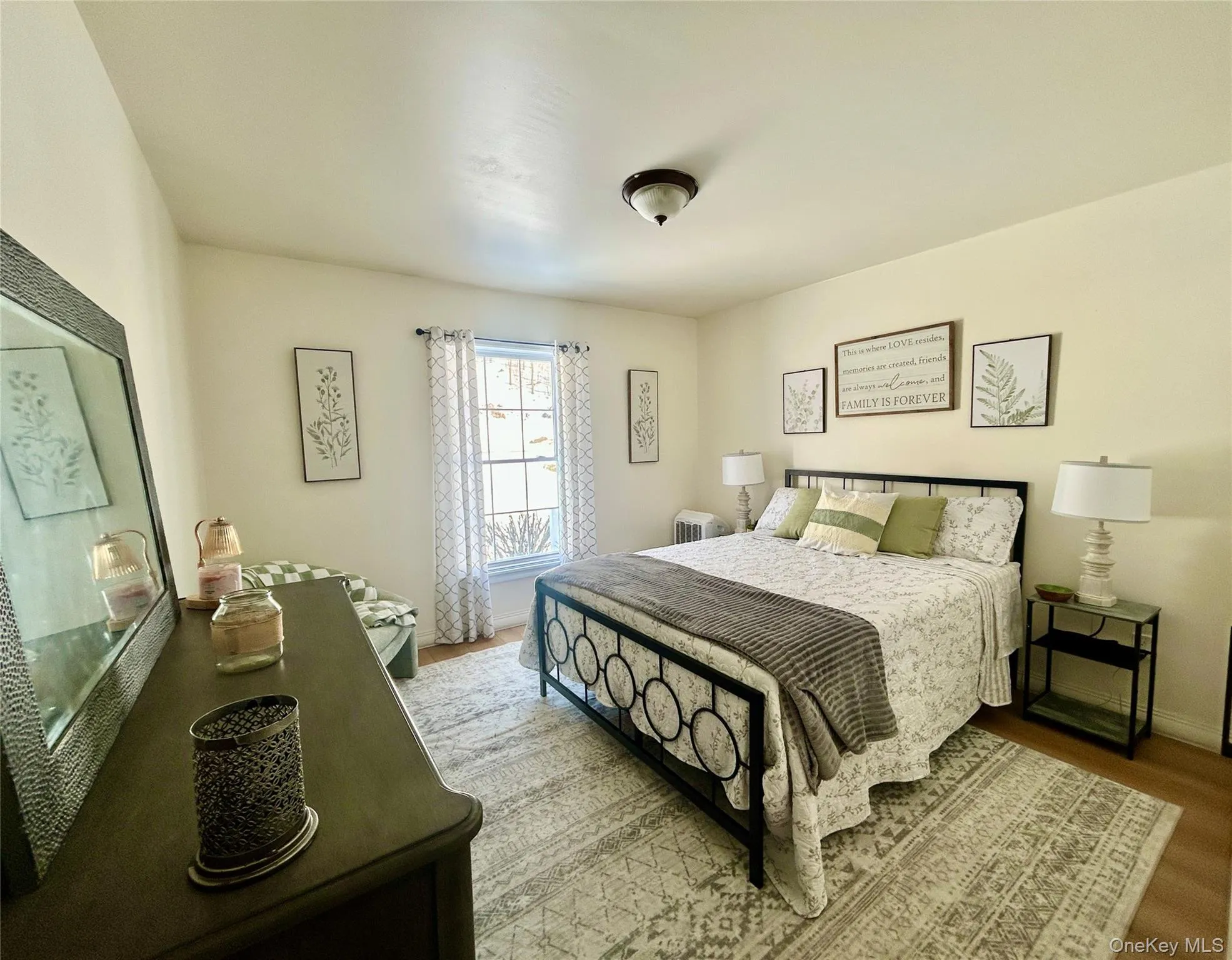 Bedroom featuring baseboards and wood finished floors Bedroom featuring baseboards and wood finished floors