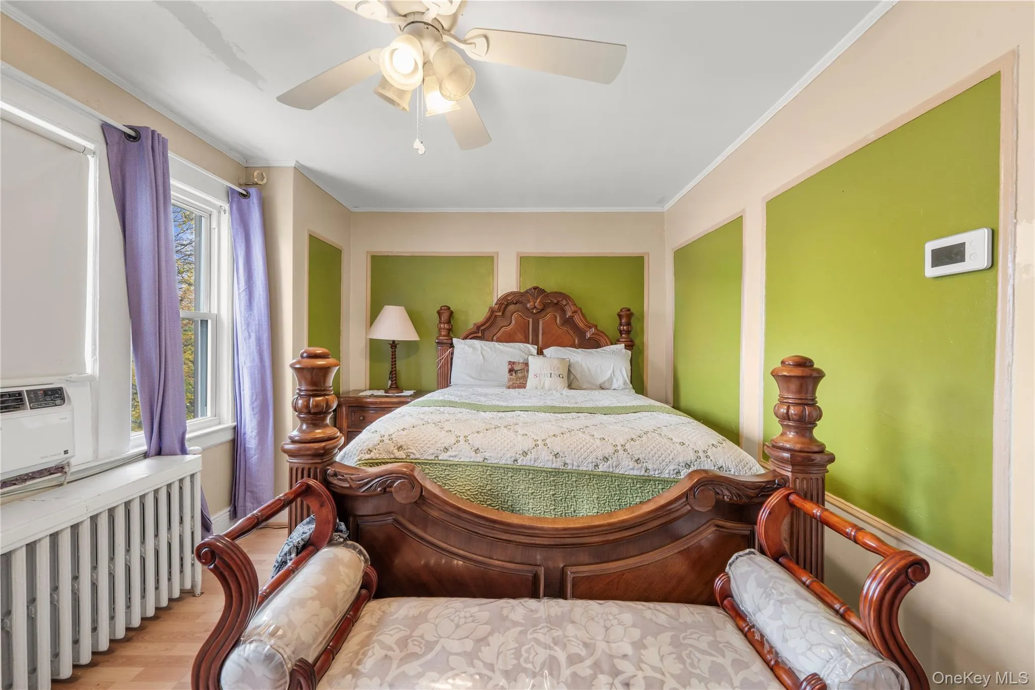 Bedroom with radiator, crown molding, wood finished floors, ceiling fan, and cooling unit Bedroom with radiator, crown molding, wood finished floors, ceiling fan, and cooling unit