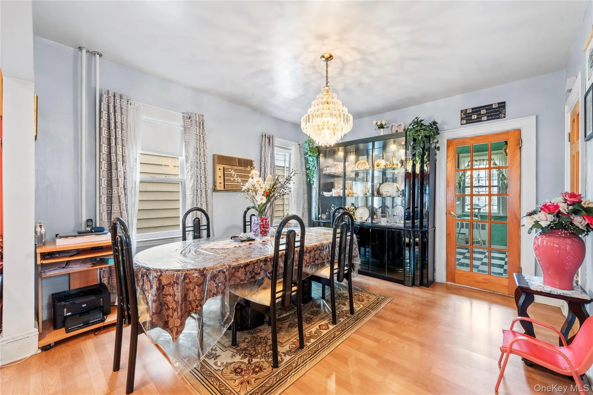 Dining area with a chandelier and light wood finished floors Dining area with a chandelier and light wood finished floors