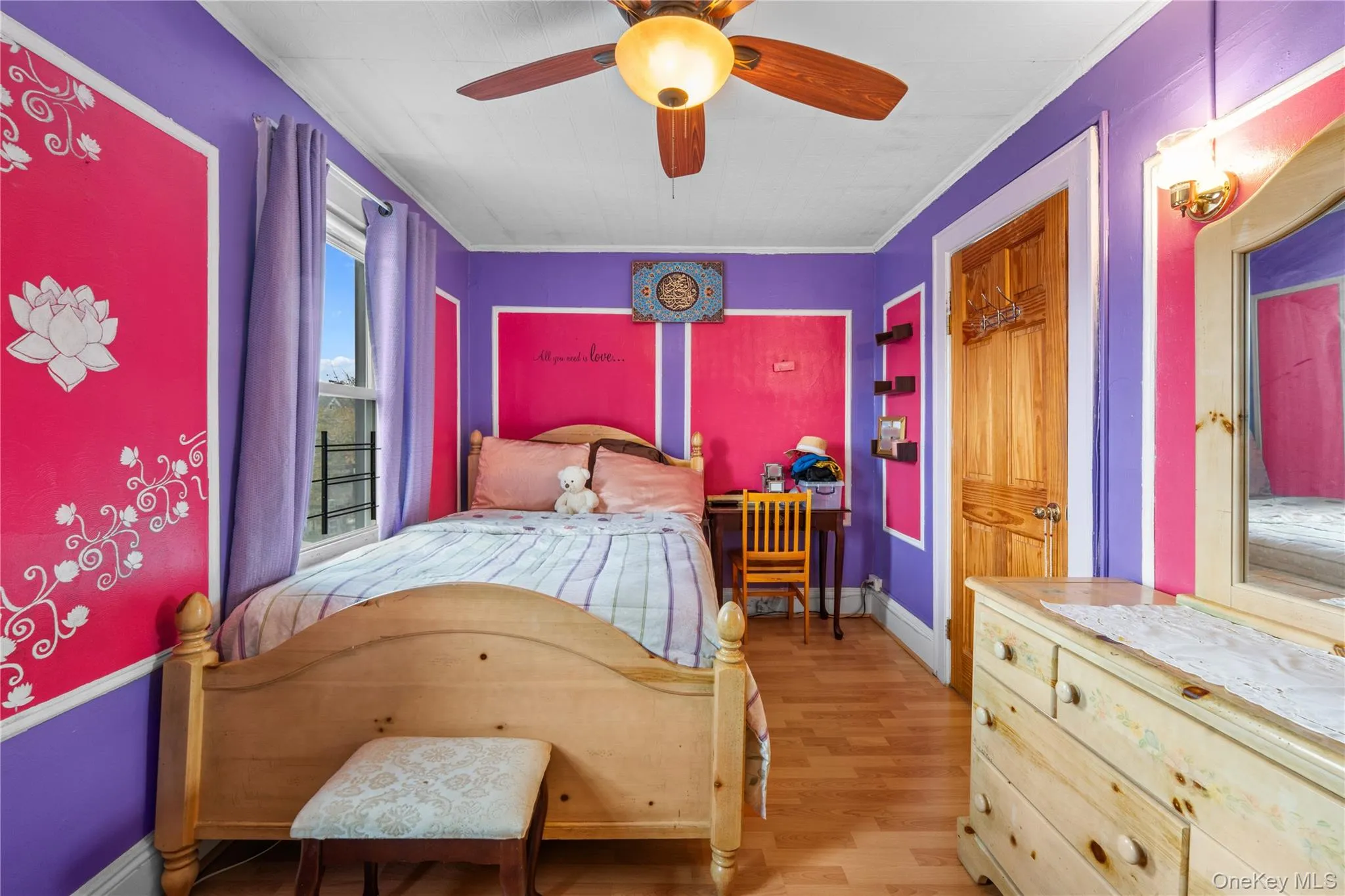 Bedroom with light wood-style flooring, a ceiling fan, and ornamental molding Bedroom with light wood-style flooring, a ceiling fan, and ornamental molding