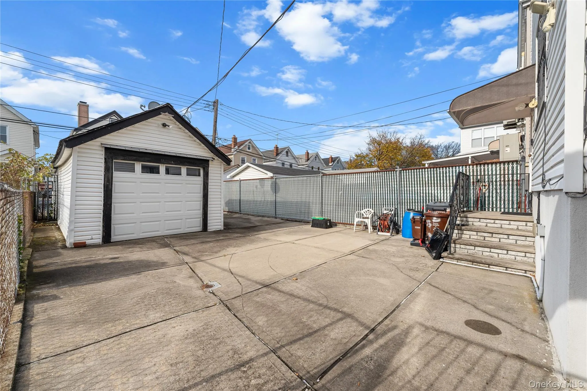 Detached garage featuring driveway Detached garage featuring driveway