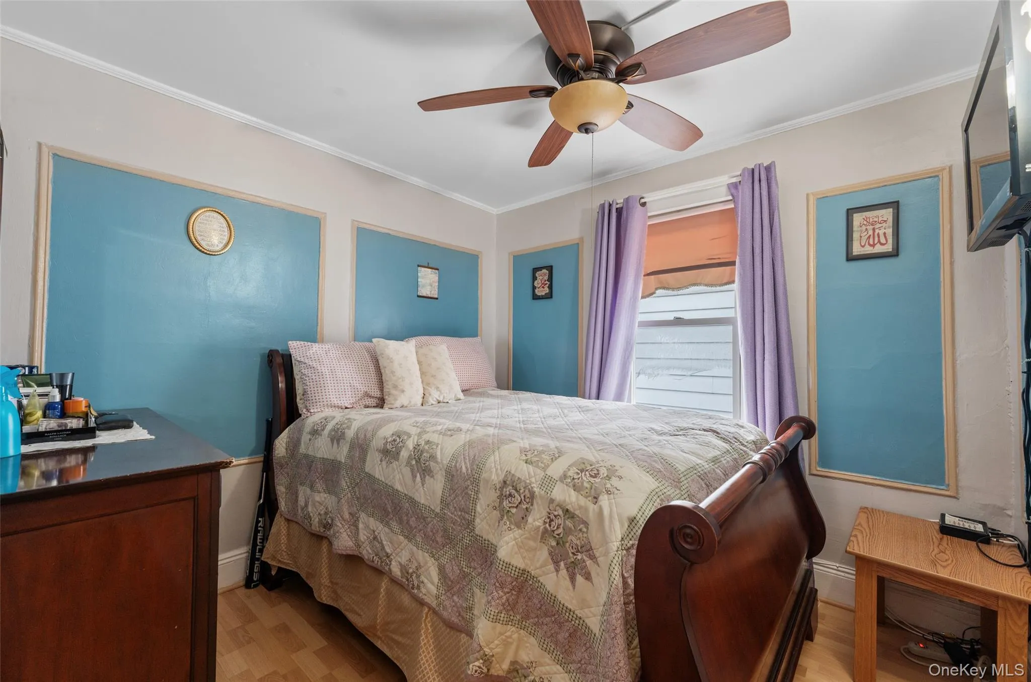 Bedroom featuring ornamental molding, light wood-style flooring, and ceiling fan Bedroom featuring ornamental molding, light wood-style flooring, and ceiling fan