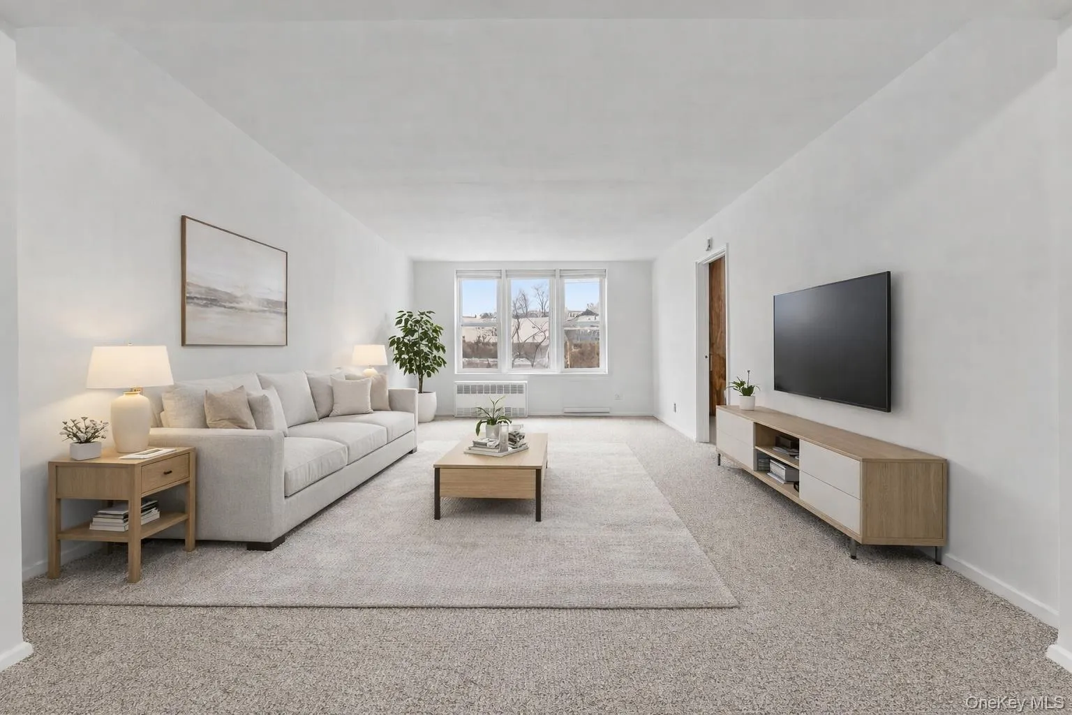 Virtually staged. Living area featuring carpet flooring and radiator heating unit Virtually staged. Living area featuring carpet flooring and radiator heating unit